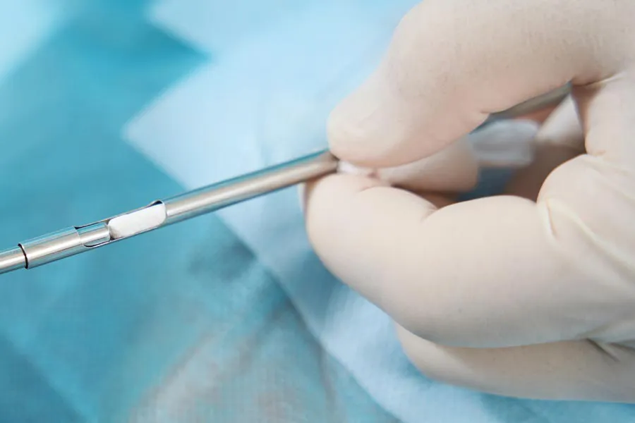 Hormone-Pellet-Therapy Close up of a doctor inserting a hormone pellet into a delivery device for hormone pellet treatments from Genifer Chavez, MD in Tucson.