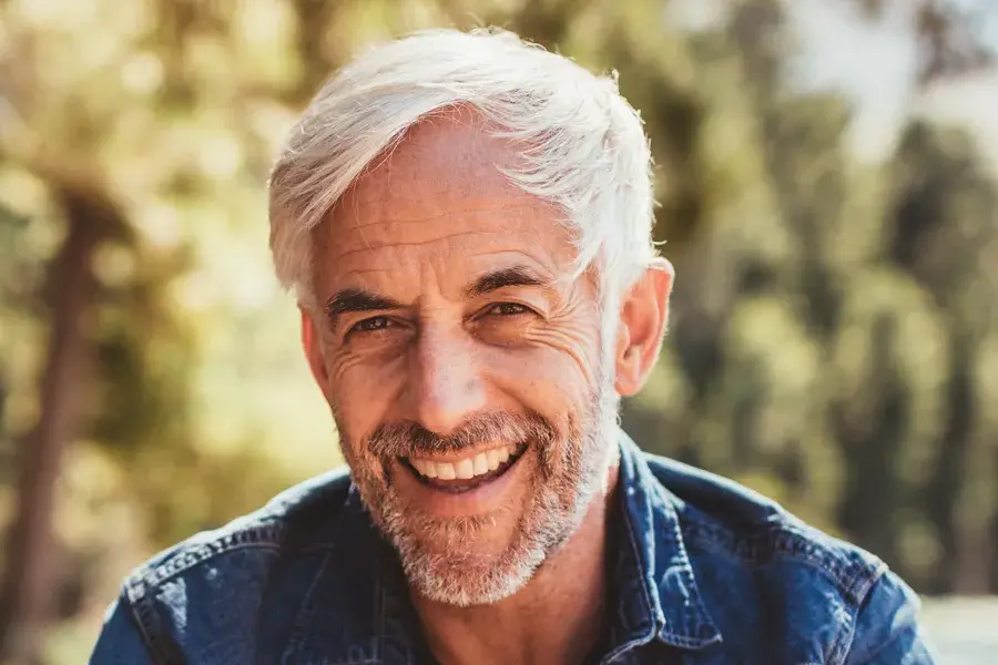 Mens-Health-Clinic A handsome mature man smiling in the forest. Make an appointment with men's health expert Genifer Chavez, MD in Tucson today.